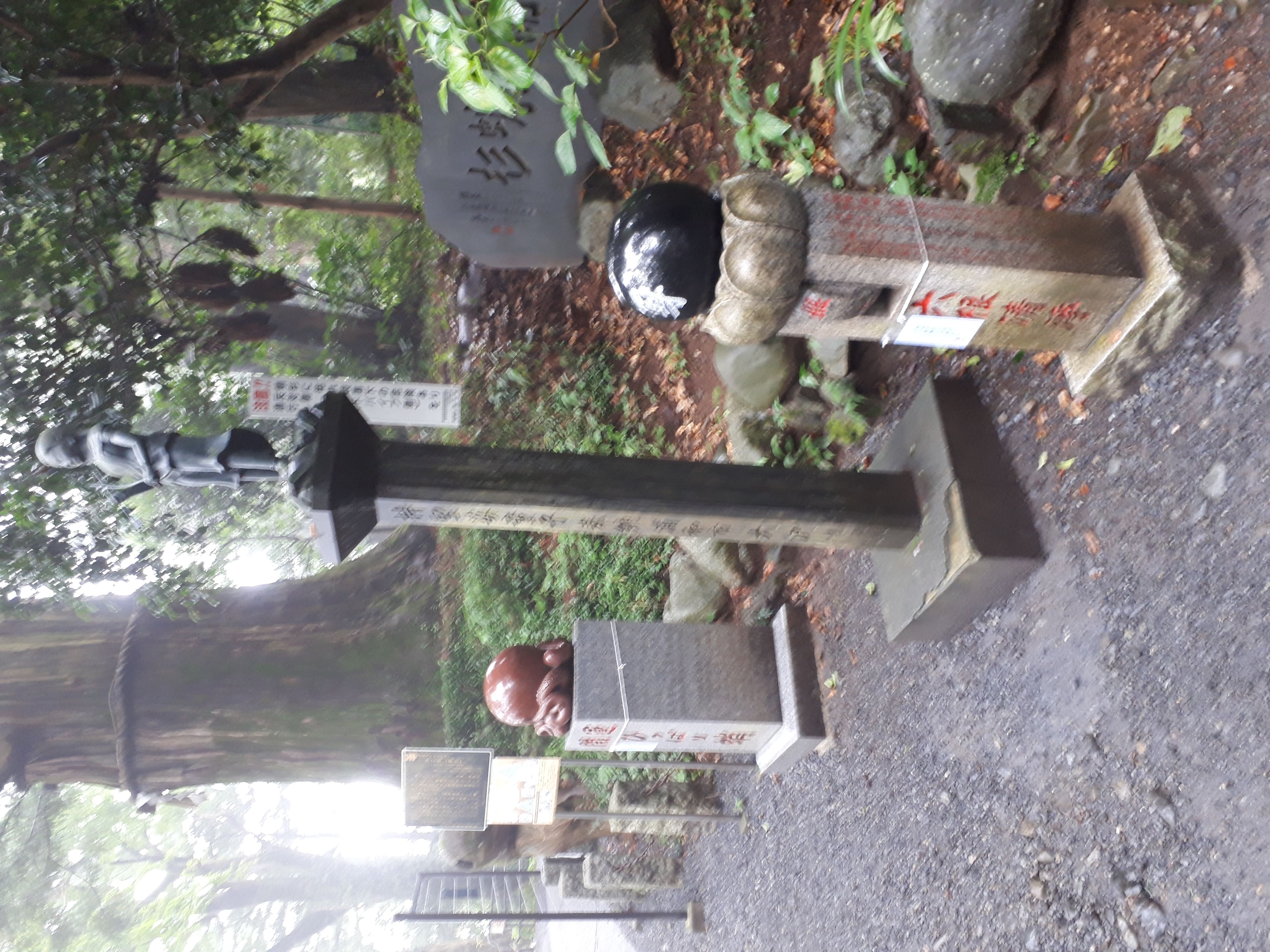 Stone monuments and statues in the misty temple grounds